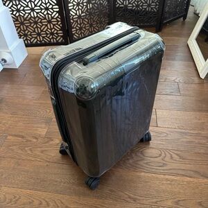 Clear protective luggage cover with a black zipper for Rimowa Cabin S 22-inch